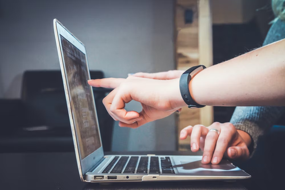 Investors assessing ESG scores on a laptop